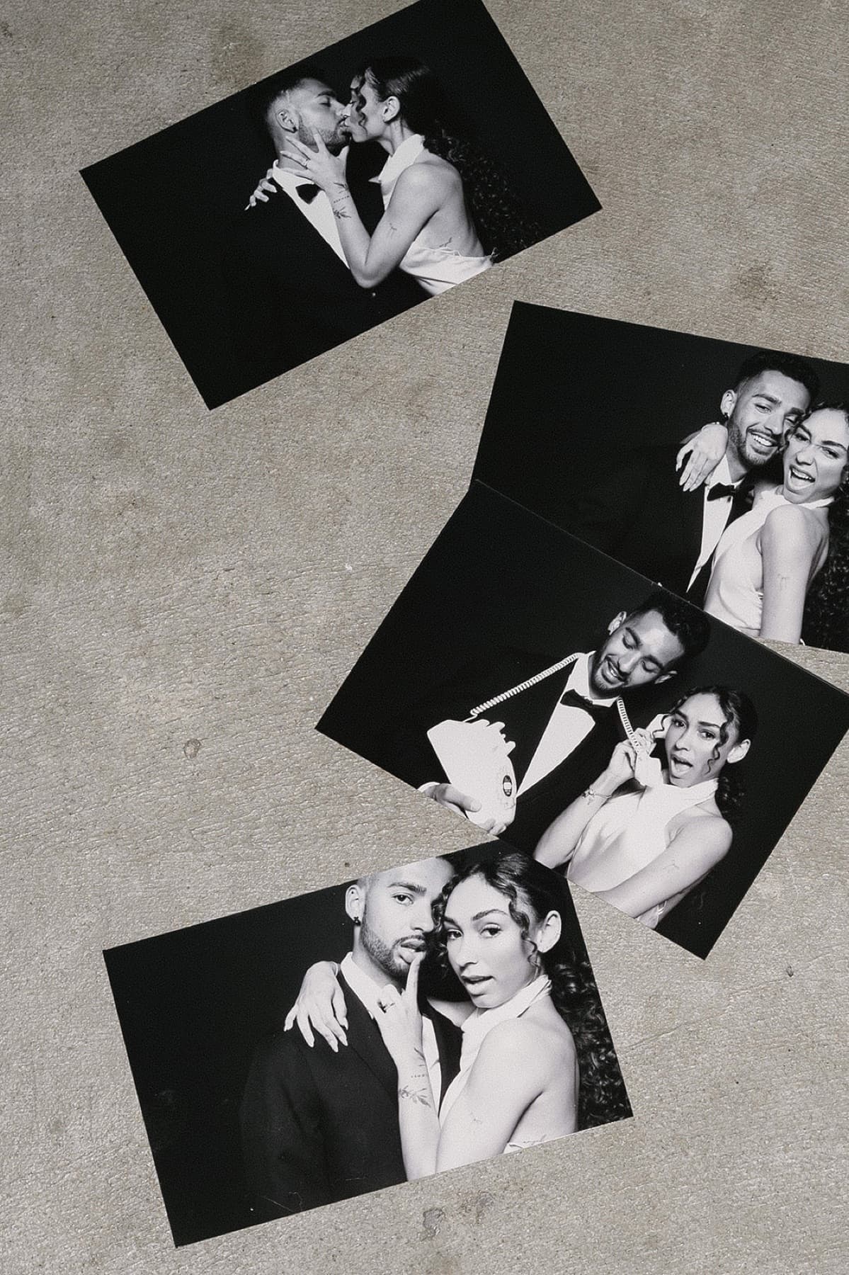 Late-night portrait prints fanned out beside the MEMORI booth.