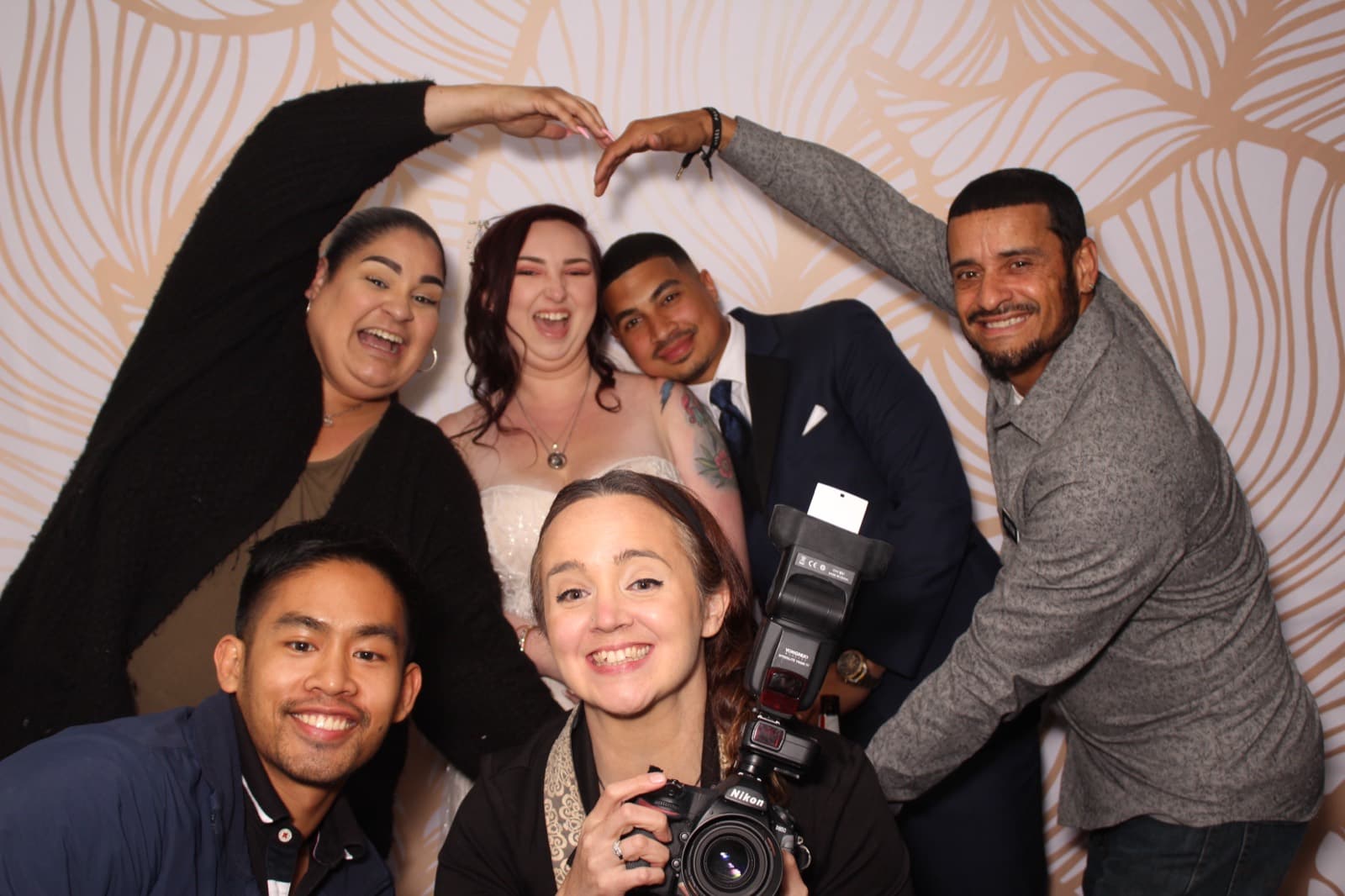 Thomas and the wedding photography team celebrating with the newlyweds at the booth.